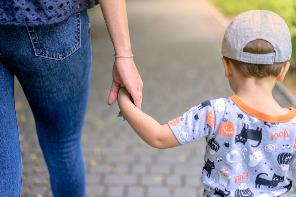 mom holding toddler's hand
