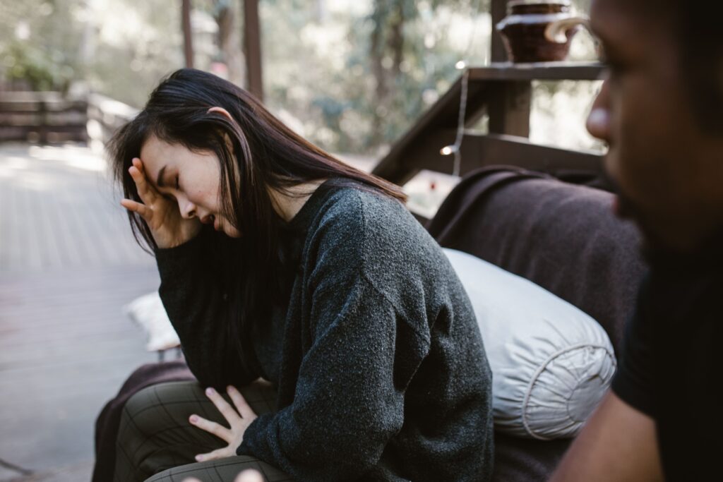 couple sitting together, woman looking sad