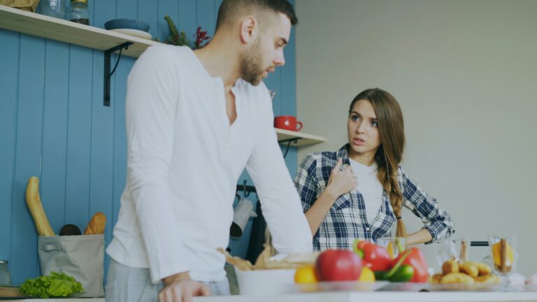 couple talking in kitchen