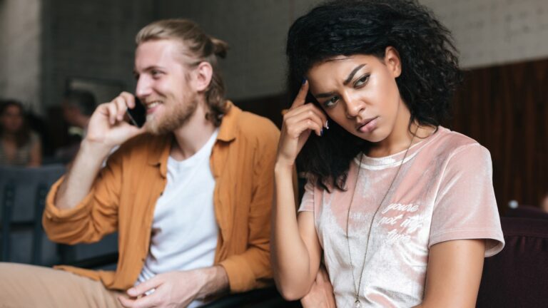 Portrait of young man and woman sitting in restaurant