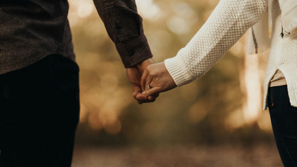 woman and man holding hands