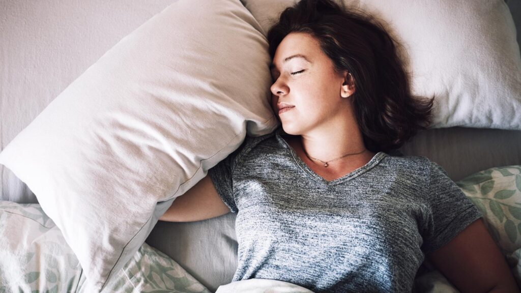 Getting some well needed rest High angle shot of an attractive young woman sleeping on her bed in the morning at home