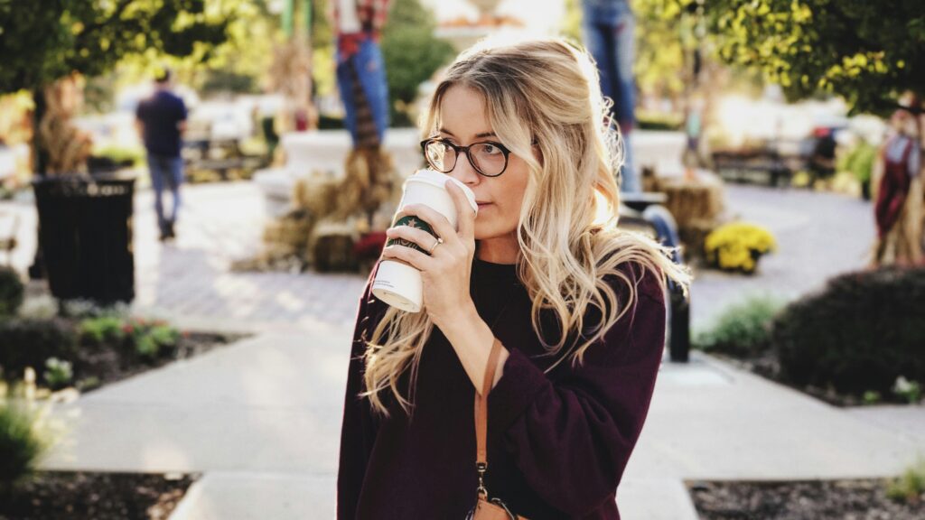 woman drinking on white cup