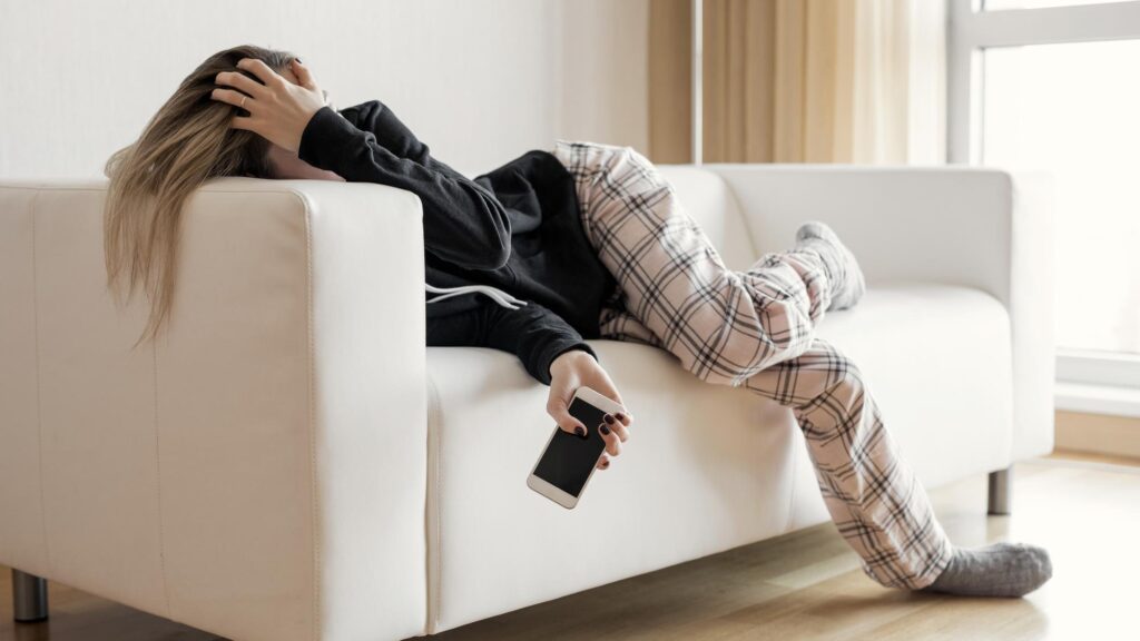 Apathic lazy woman lying in sofa