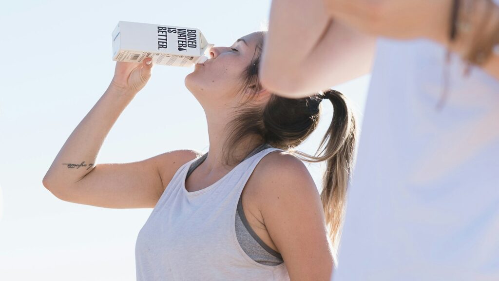 Two women working out and drinking Boxed Water