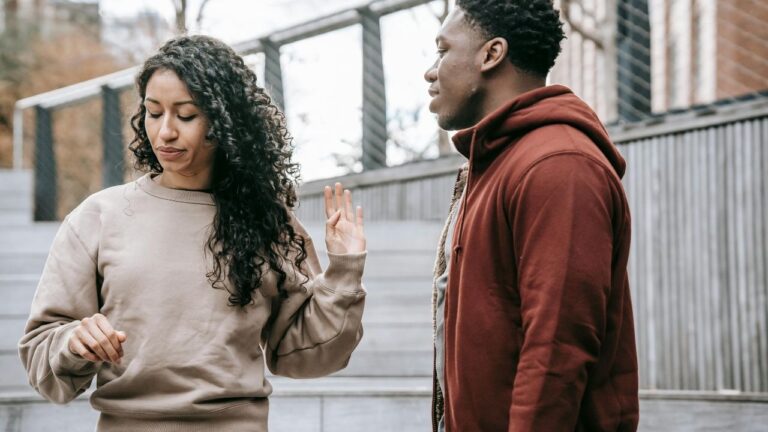 Multiethnic couple arguing on stree