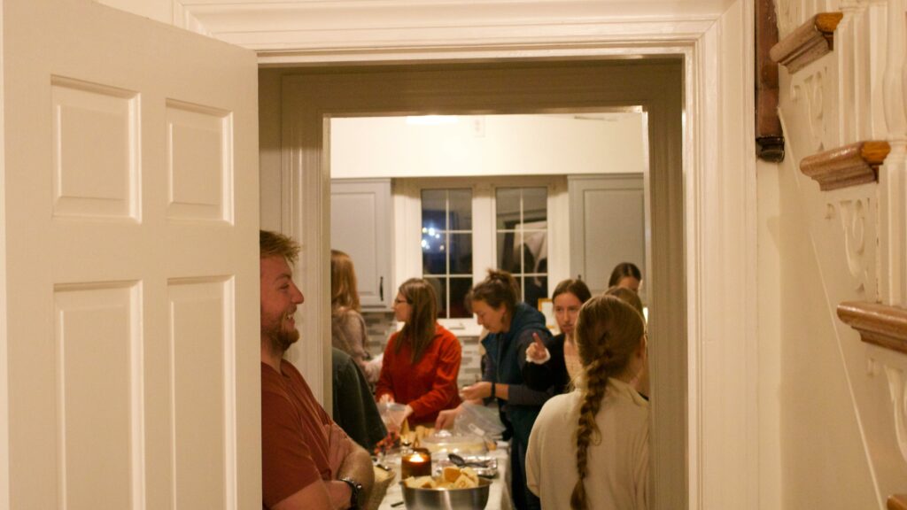 People gathered in a kitchen during a party.