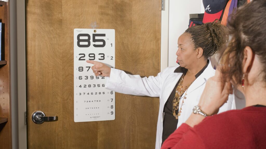 a woman pointing at a sign on a door