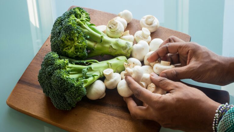 white garlic on brown wooden chopping board