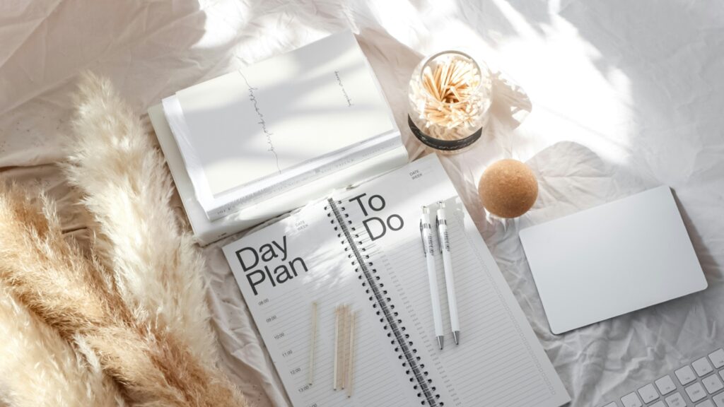 white pen on white notebook