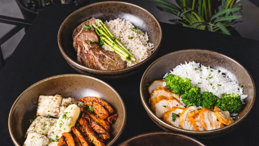 cooked food on black ceramic bowls