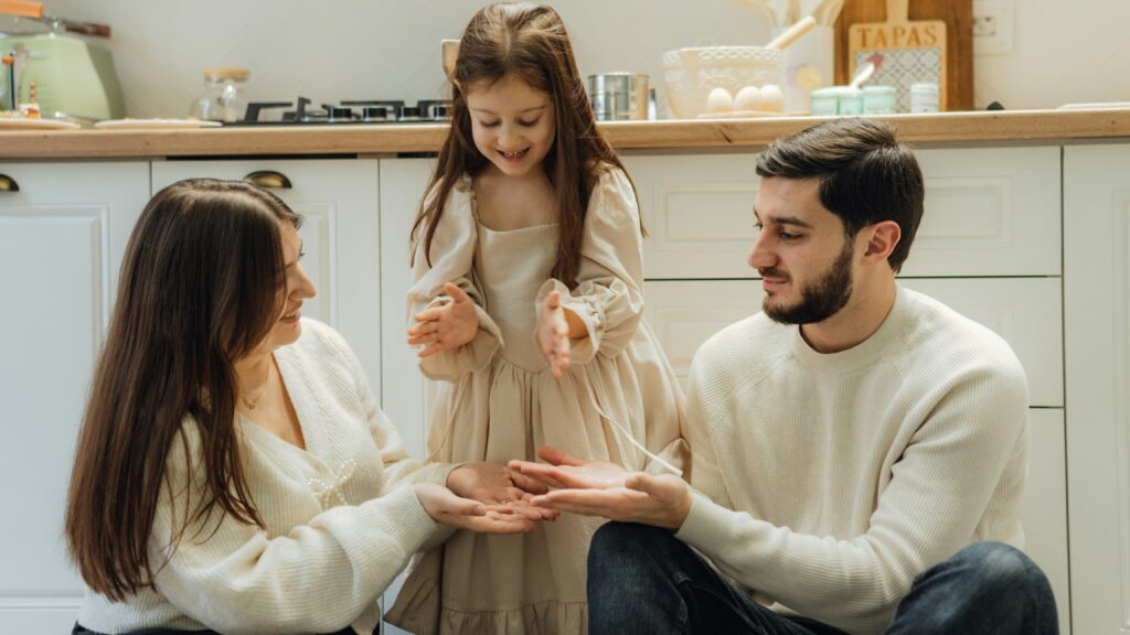 A group of people sitting around in a kitchen