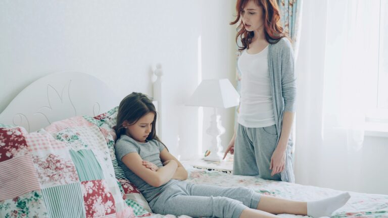 A mother confronts her child, who is upset.