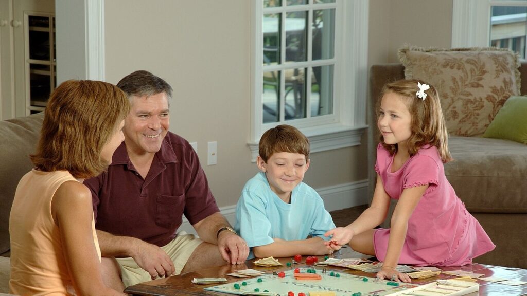 Title Family Playing a Board Description A Caucasian family (adult male and female and two children, male and female) are sitting around a coffee table playing a board game. Topics/Categories People -- Adult People -- Child People -- Family/Friends People -- Recreation Type Color, Photo Source National Cancer Institute (NCI)