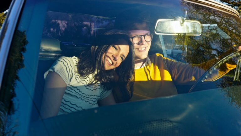a man and a woman sitting in a car