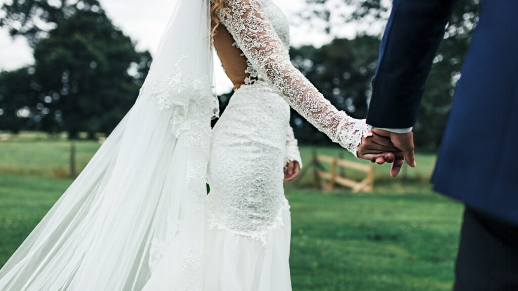 bride and groom holding hans