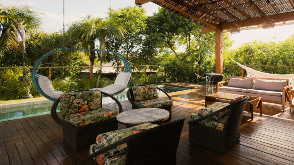 Covered patio with seating, hammock, and pool view.