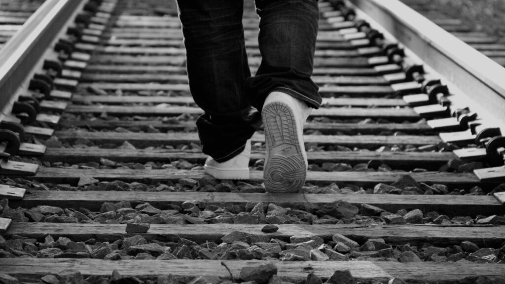 Person walking on railroad tracks