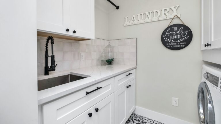 a laundry room with a sink and a washer and dryer