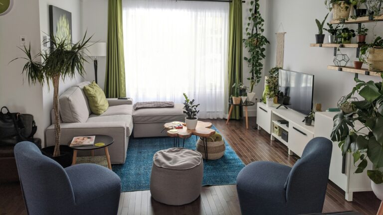 gray couch near white window curtain