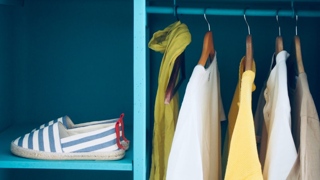 blue shelf with pair of slip-ons and five clothes
