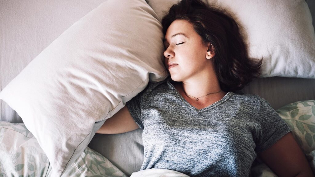 Getting some well needed rest High angle shot of an attractive young woman sleeping on her bed in the morning at home
