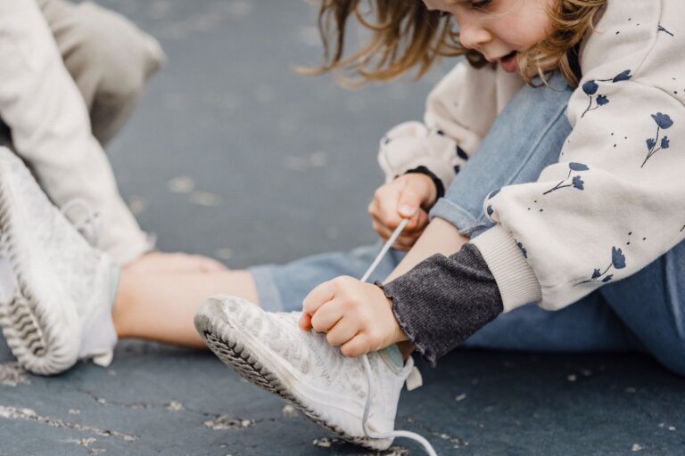 child learning to tie shoes