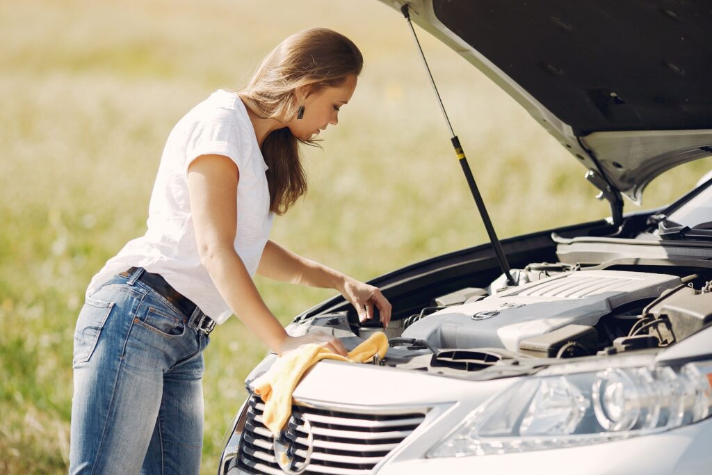 woman checking washer fluid in car