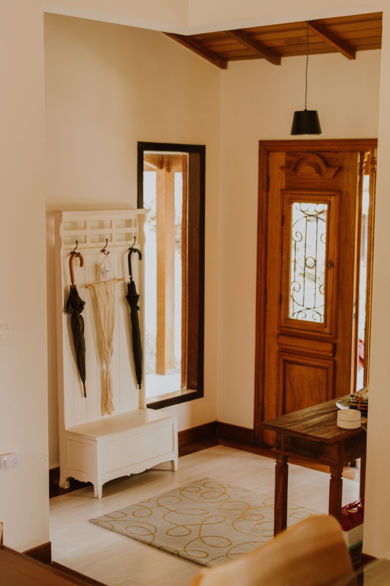 home inside entry with rug, bench, coat rack