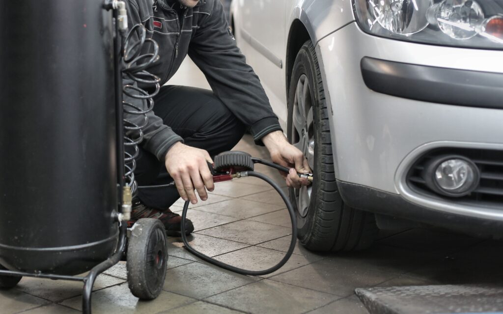 man checking tire pressure
