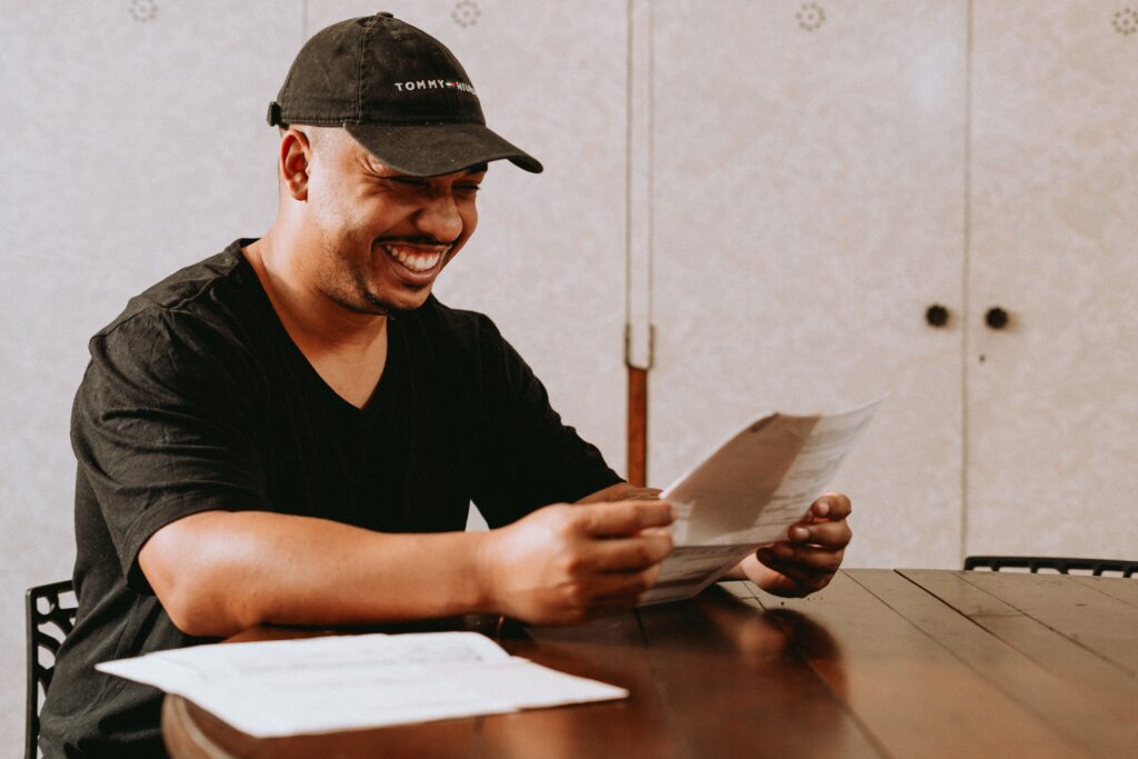 happy man looking at paid-off car loan