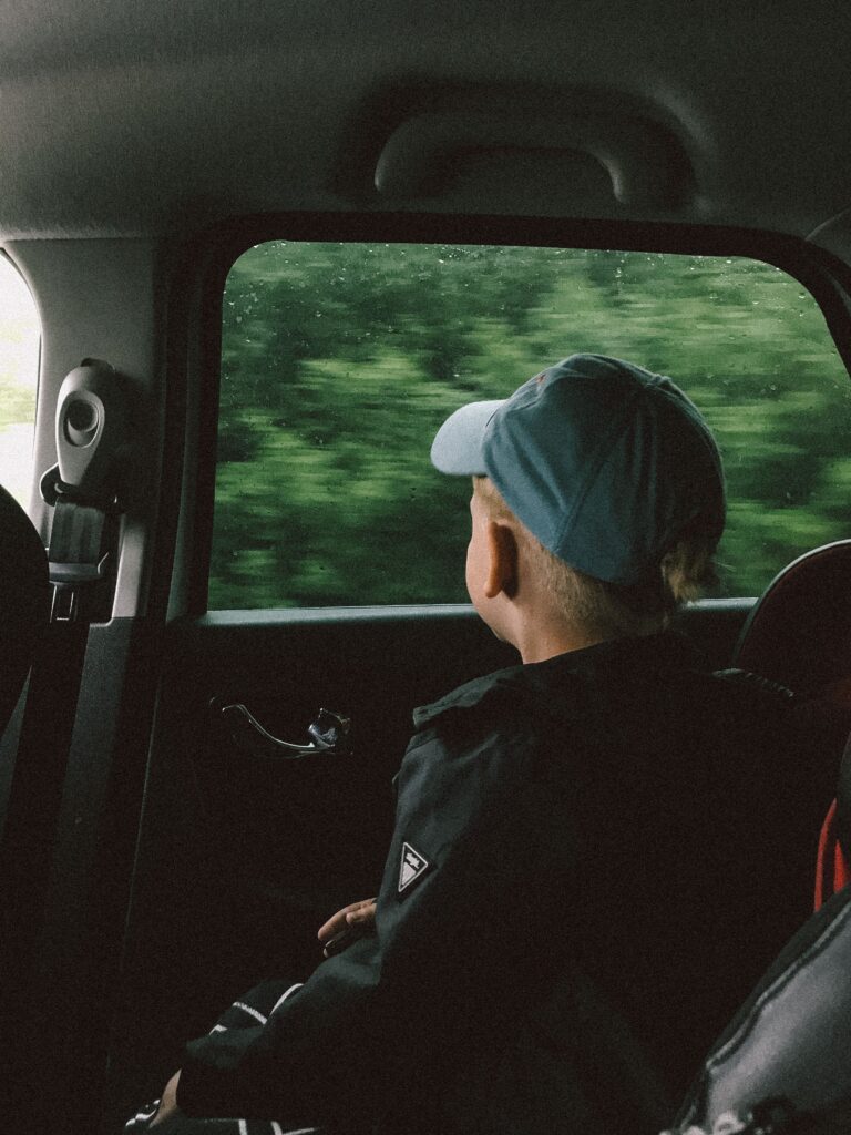 child on road trip listening to music