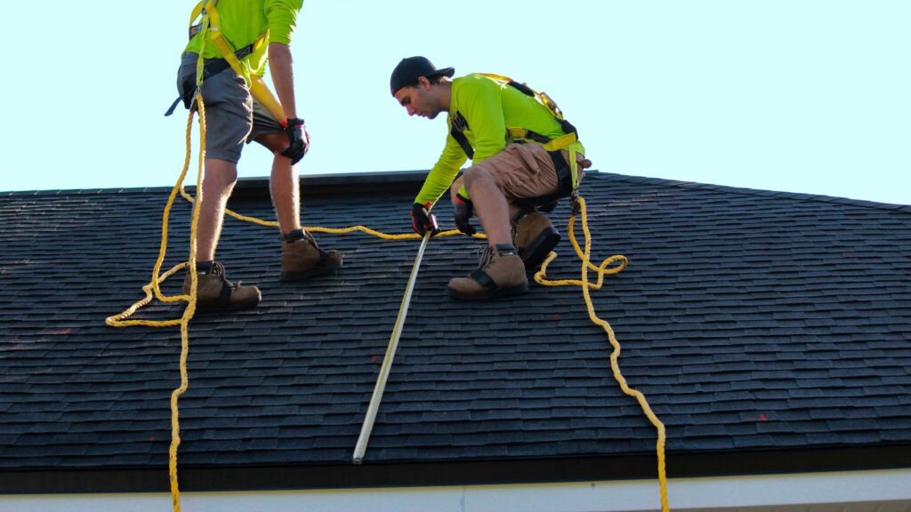 a couple of people that are on a roof
