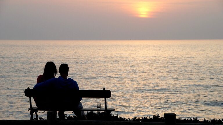 Couple looking at the sunset. Porto Covo, Portugal
