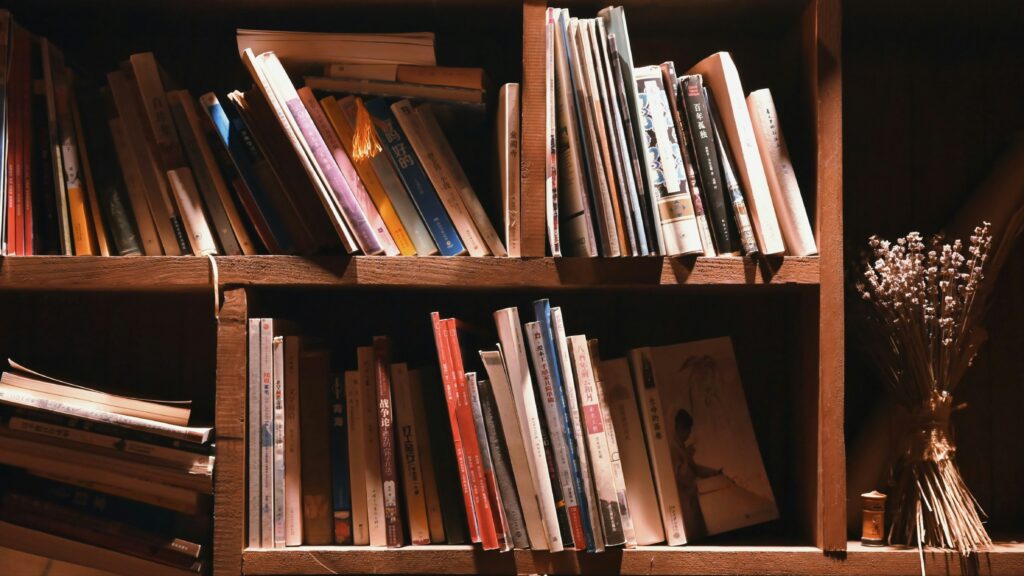 books on brown wooden shelf