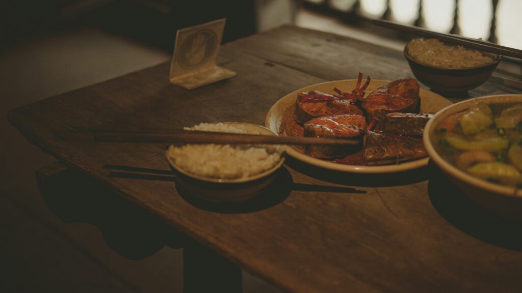 a wooden table topped with bowls of food