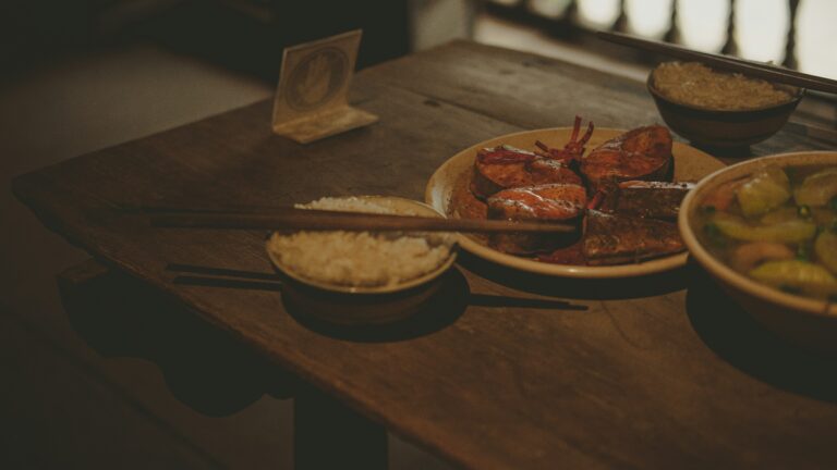 a wooden table topped with bowls of food