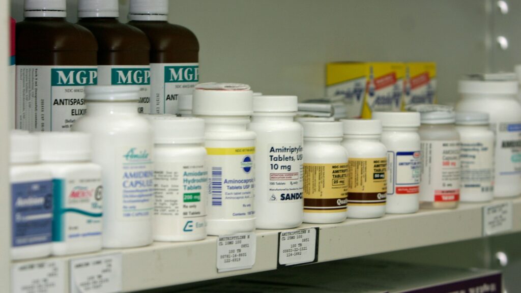a shelf filled with lots of different types of medicine