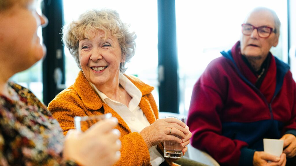 Three seniors talking and smiling together