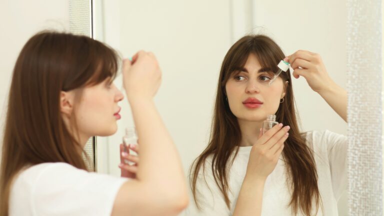 a woman brushing her hair in front of a mirror