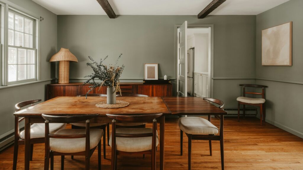 A rustic dining room with wooden table and chairs