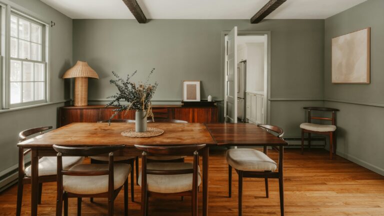 A rustic dining room with wooden table and chairs