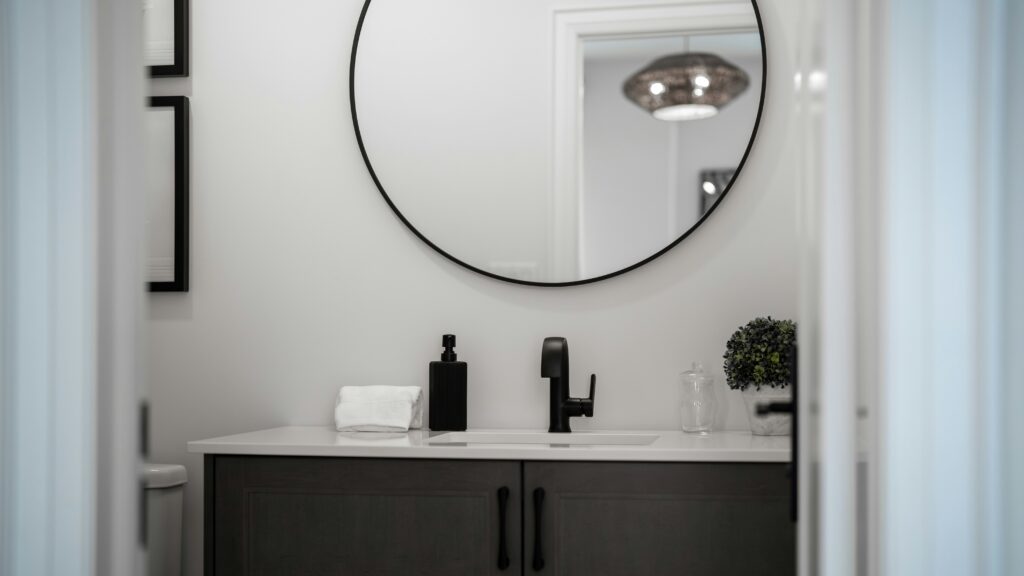 Modern bathroom vanity with a round mirror above