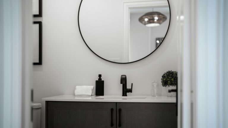 Modern bathroom vanity with a round mirror above