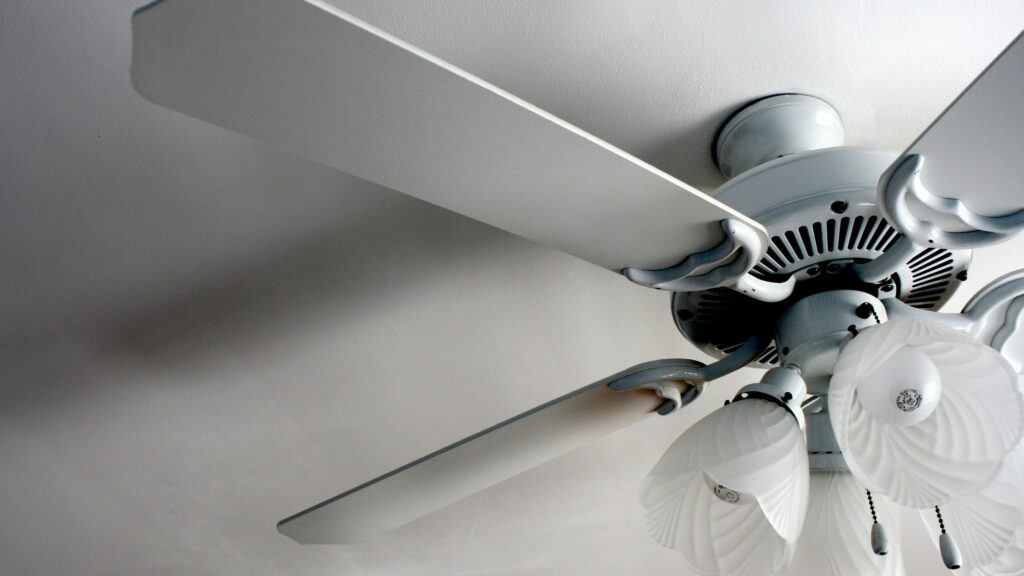 a white ceiling fan in a white room