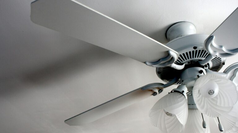 a white ceiling fan in a white room