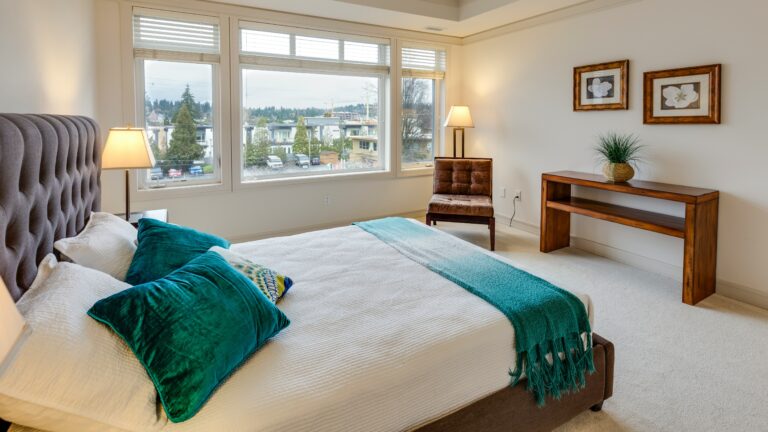 two green and white pillows on empty bed