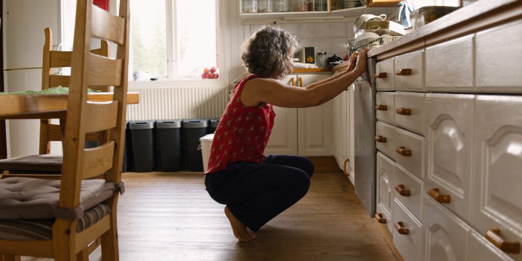 older person squatting down