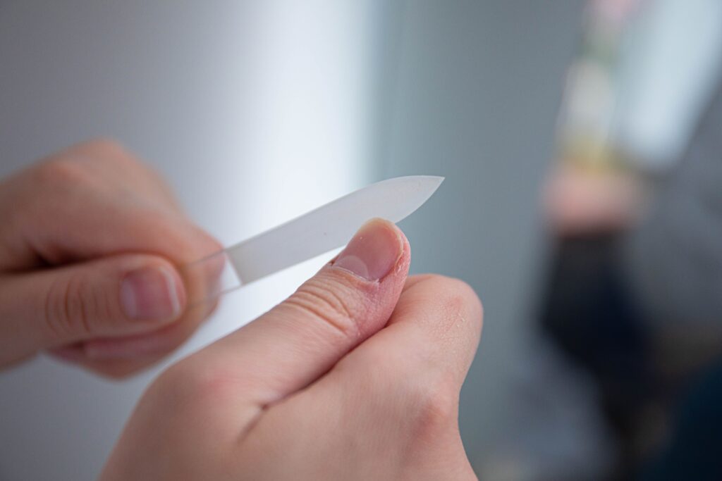 woman filing her fingernails