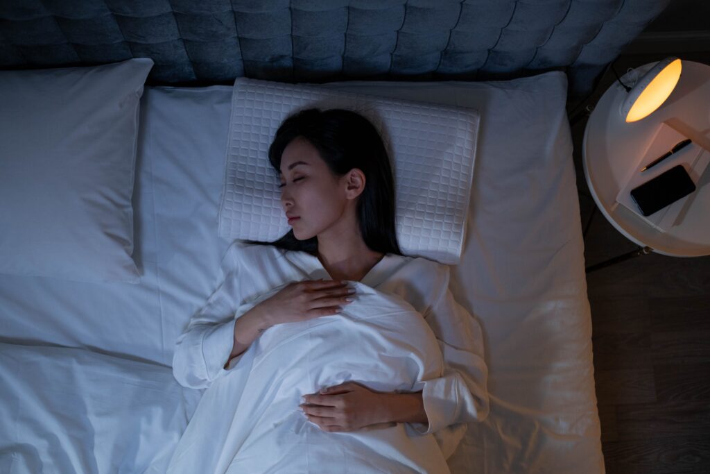 woman sleeping in bedroom with dim night light